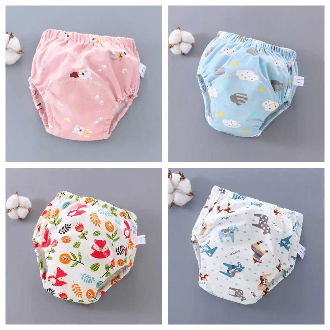Four colorful reusable baby training pants with cute animal and cloud prints on gray background