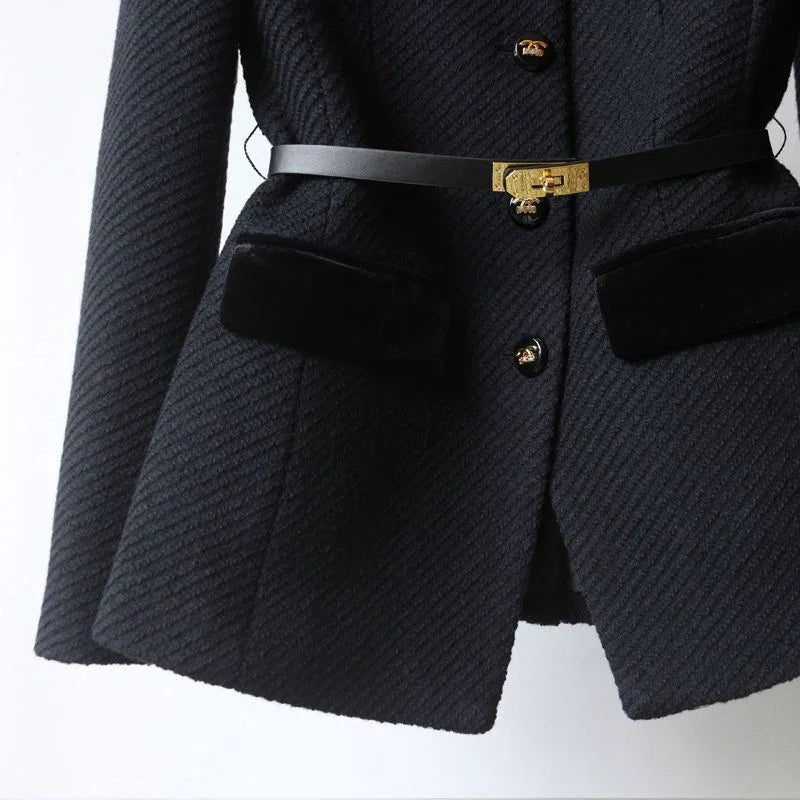 Black textured blazer with velvet pockets, gold buttons, and slim black belt with gold clasp