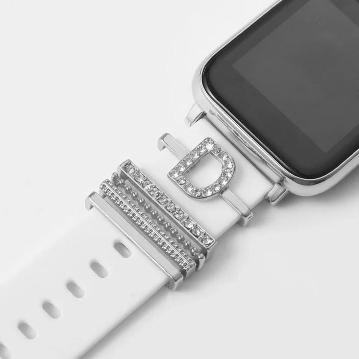 Close-up of white smartwatch band with silver and rhinestone decorative charms