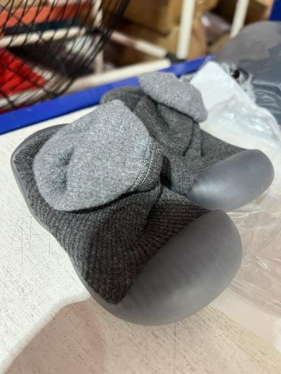 Pair of grey pet paw boots with soft fabric and rubber soles on a table