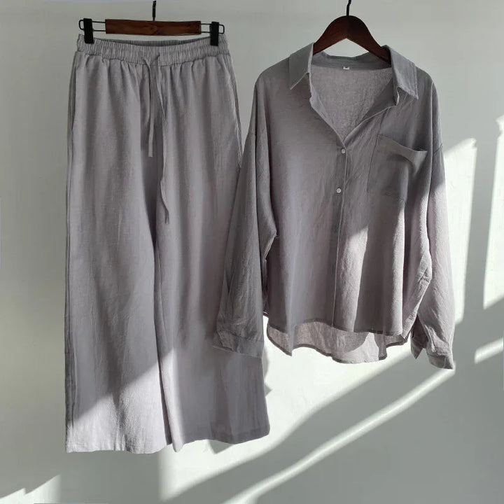Light gray linen long-sleeve button-up shirt and matching wide-leg pants on wooden hangers