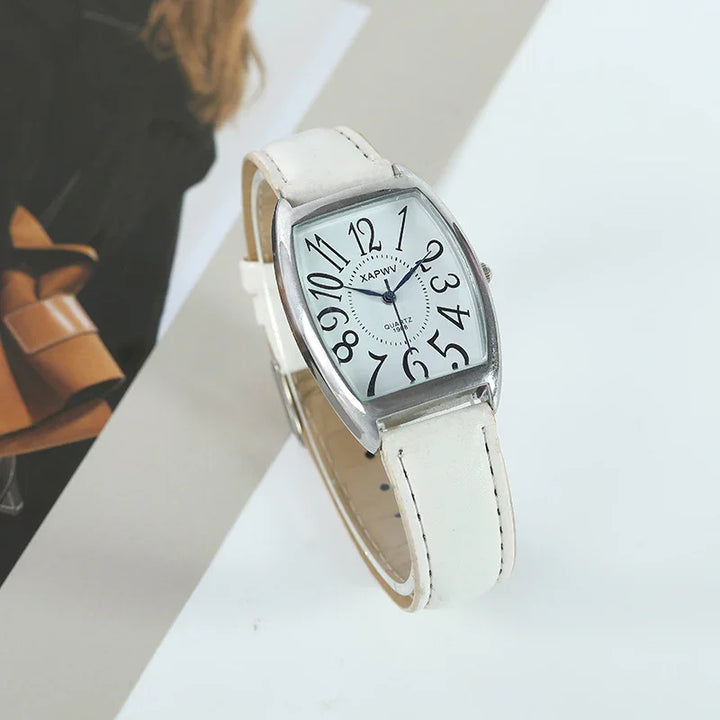 White leather strap wristwatch with silver curved rectangular case and large black numerals on white dial