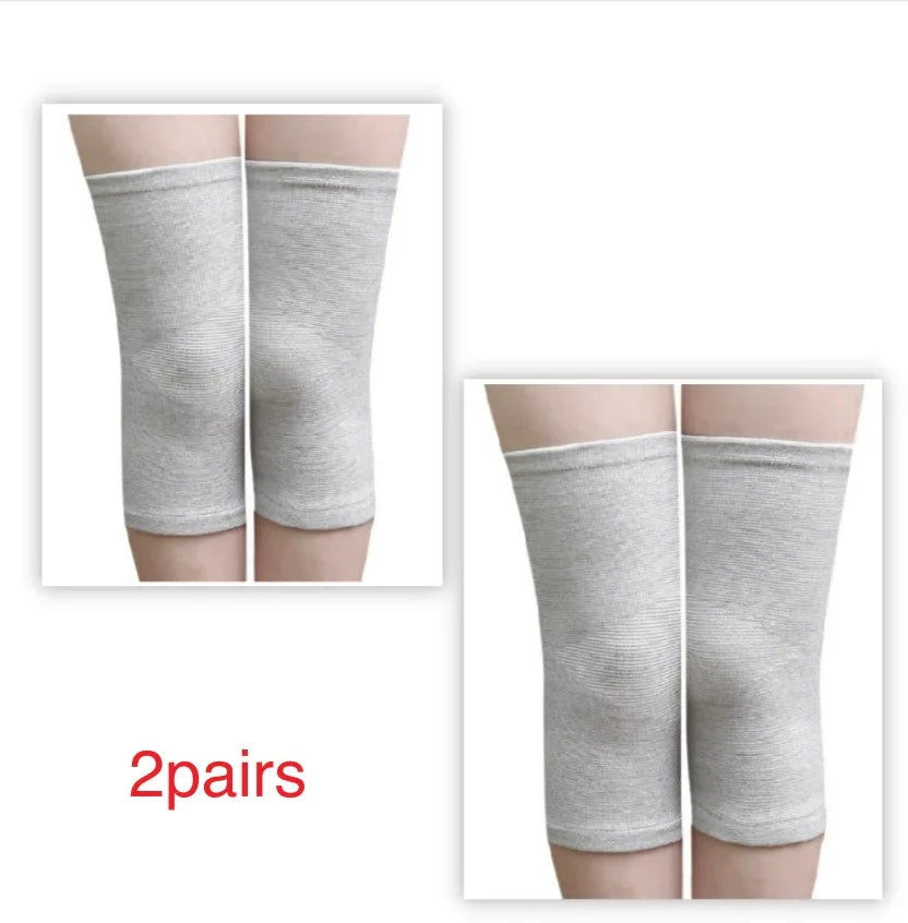 Two pairs of light grey knee sleeves for joint support on legs