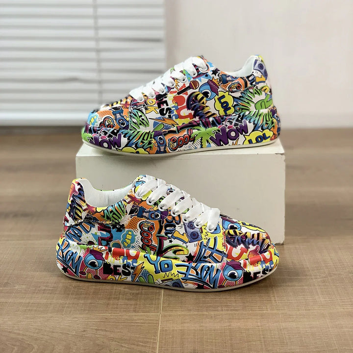 Colorful graffiti print sneakers with white laces displayed on wooden floor and white box