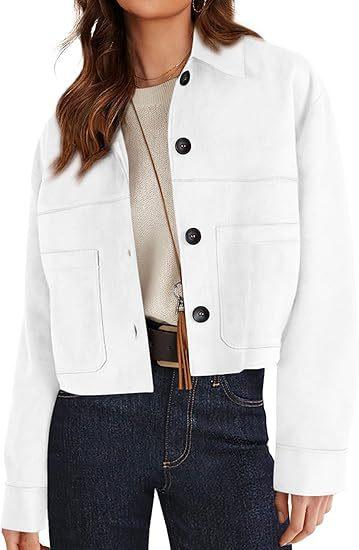 Woman wearing white button-up jacket with large front pockets, beige top, and dark blue jeans