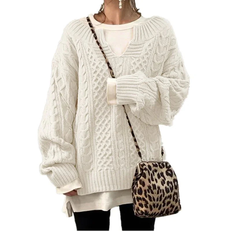 Woman wearing oversized white cable knit sweater with leopard print crossbody bag