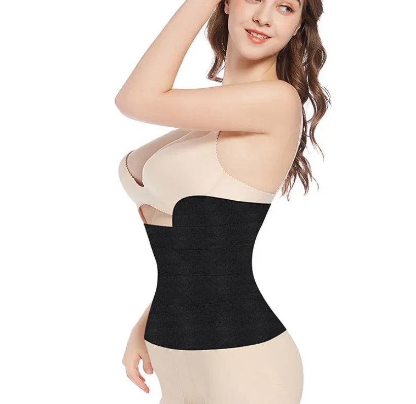 Woman wearing black waist trainer corset shapewear and beige undergarments on white background
