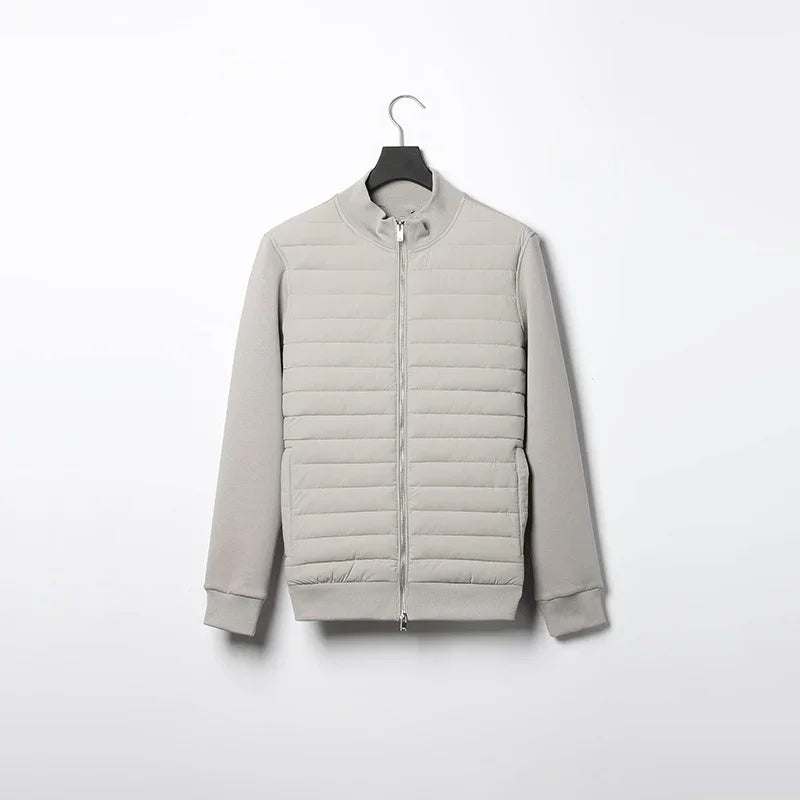 Light gray padded jacket with full front zipper and ribbed cuffs hanging on black hanger