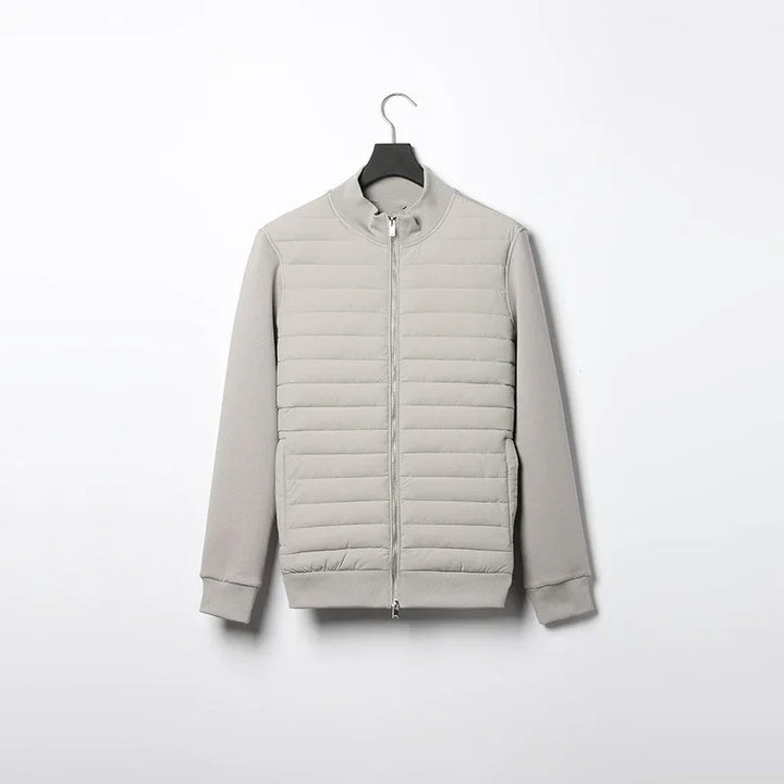 Light gray padded jacket with full front zipper and ribbed cuffs hanging on black hanger