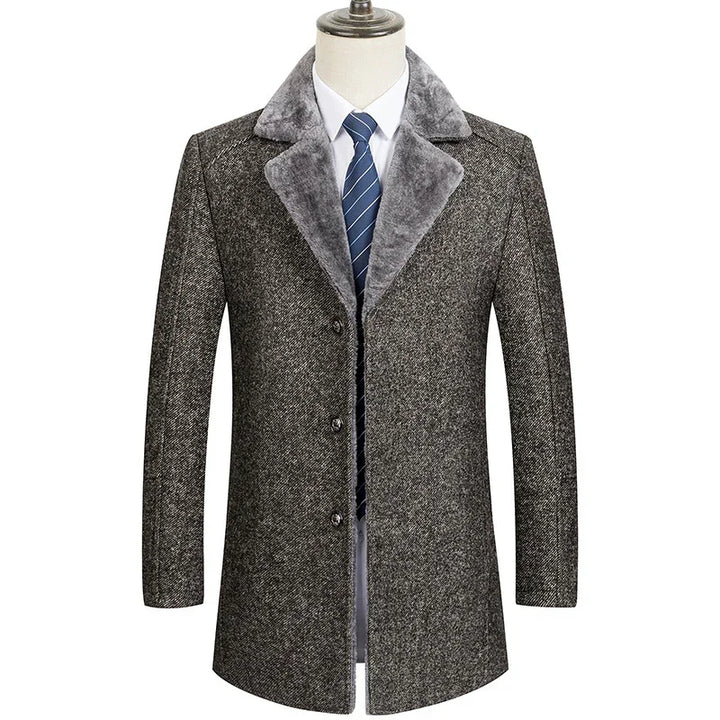 Men's grey wool coat with plush collar, white shirt, and blue striped tie on mannequin
