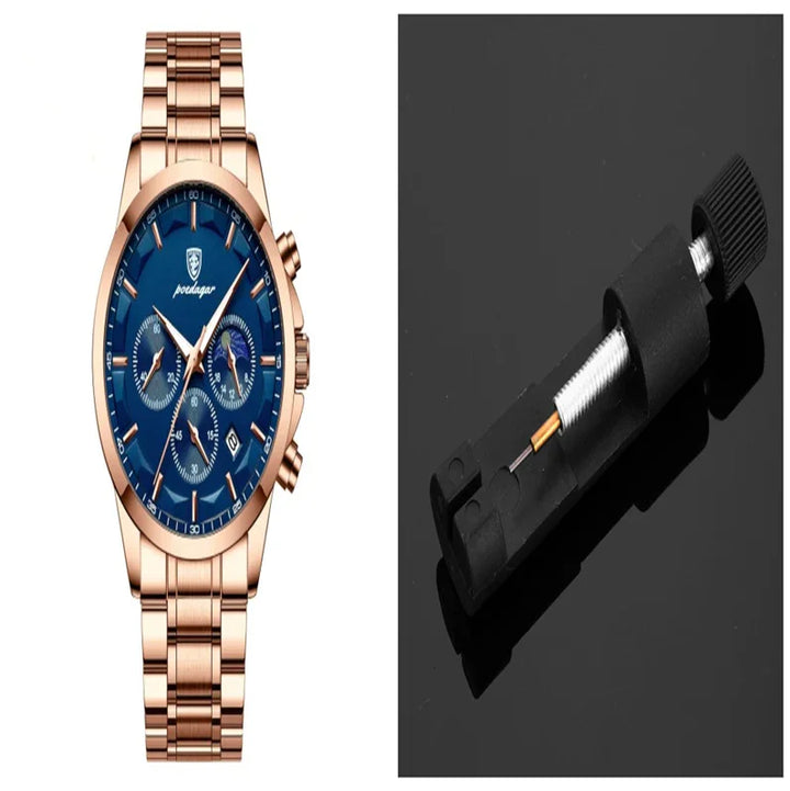 Rose gold wristwatch with blue dial and chronograph beside black watch band spring bar tool
