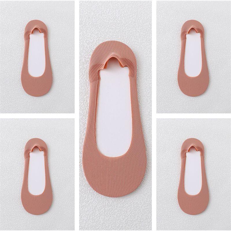 Light brown ribbed no-show socks with scalloped edge and silicone heel grips on white background