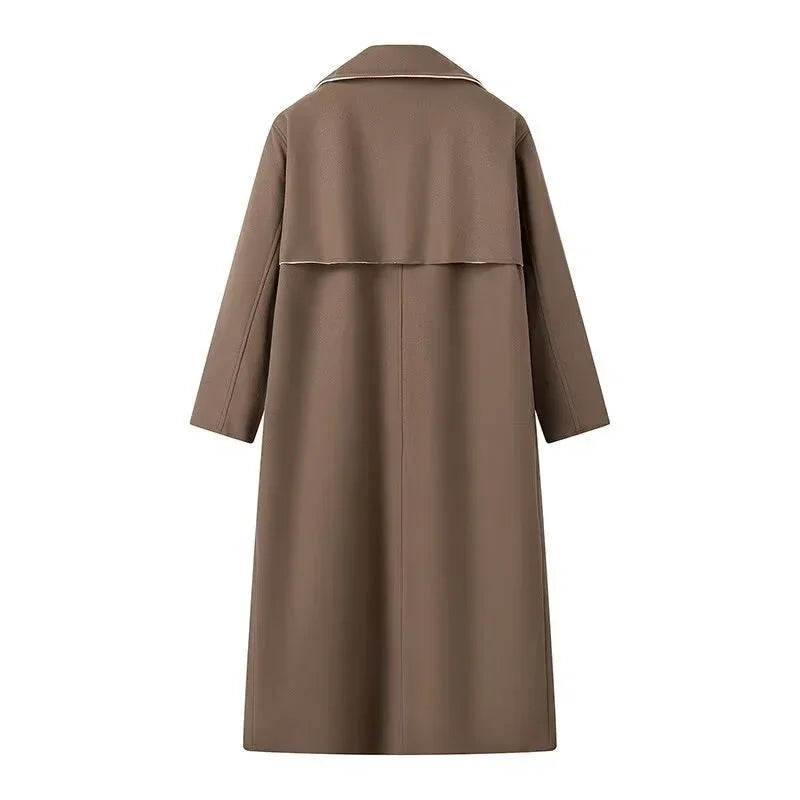 Back view of long brown trench coat with wide collar and storm flap detail