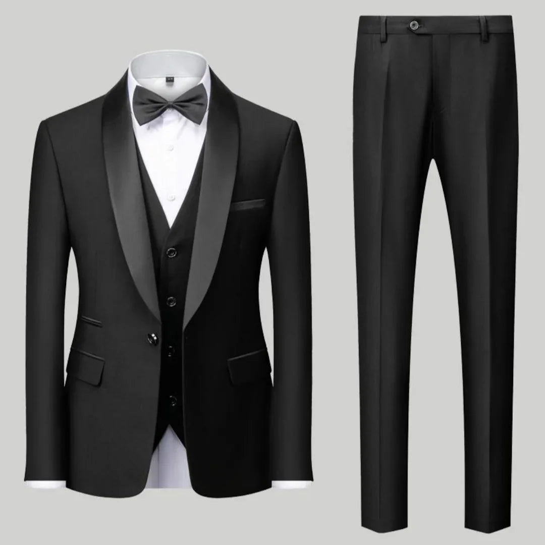 Black tuxedo suit with satin lapel, white dress shirt, black bow tie, and matching trousers