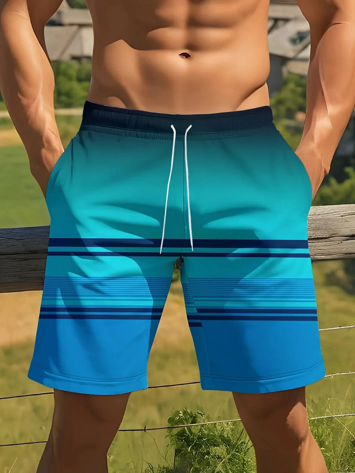 Athletic man wearing blue gradient striped swim trunks standing outdoors by a wooden fence