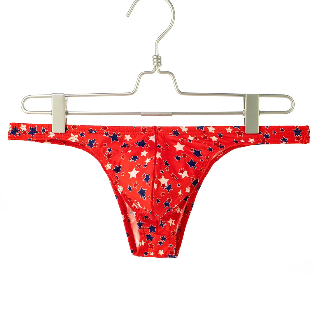 Red bikini bottom with white and blue star pattern hanging on metal hanger