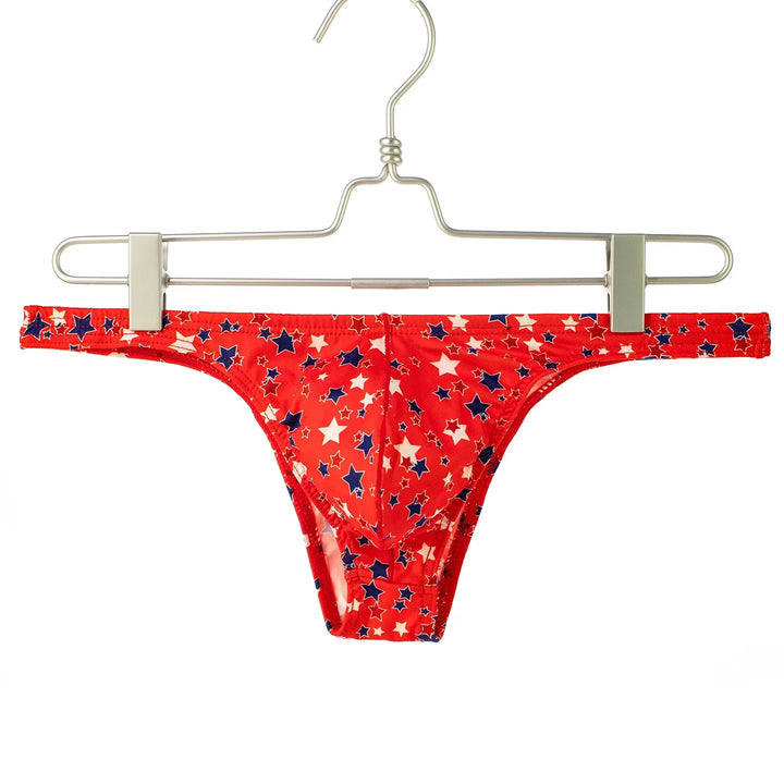 Red bikini bottom with white and blue star pattern hanging on metal hanger
