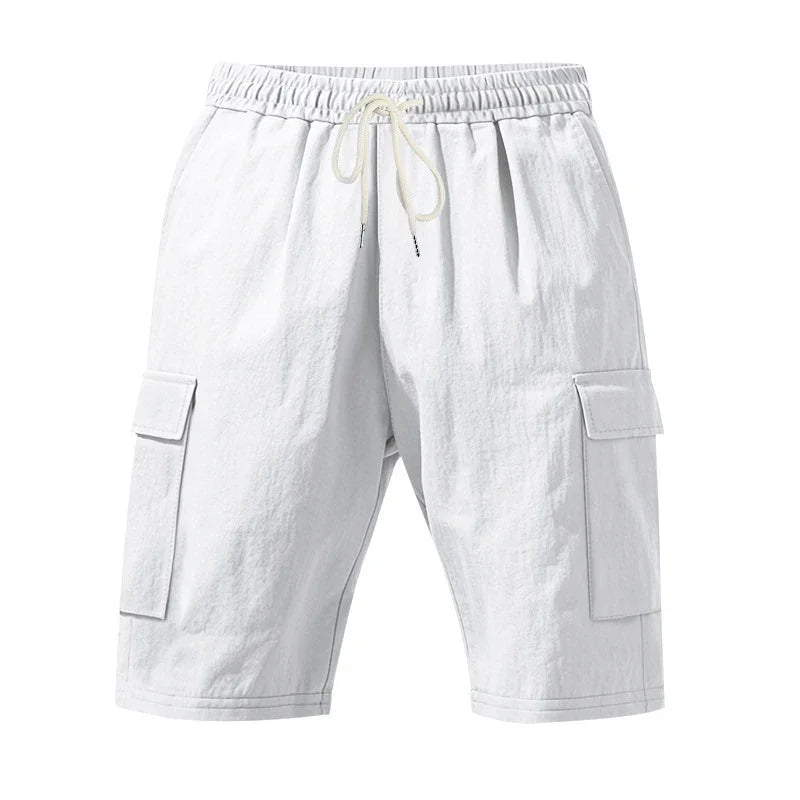 White cargo shorts with elastic waistband and drawstring, featuring side flap pockets