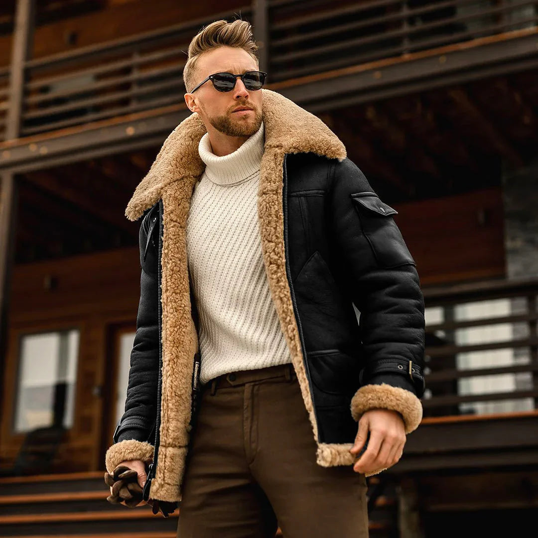 Stylish man wearing black shearling jacket with tan fur lining and white turtleneck sweater outdoors