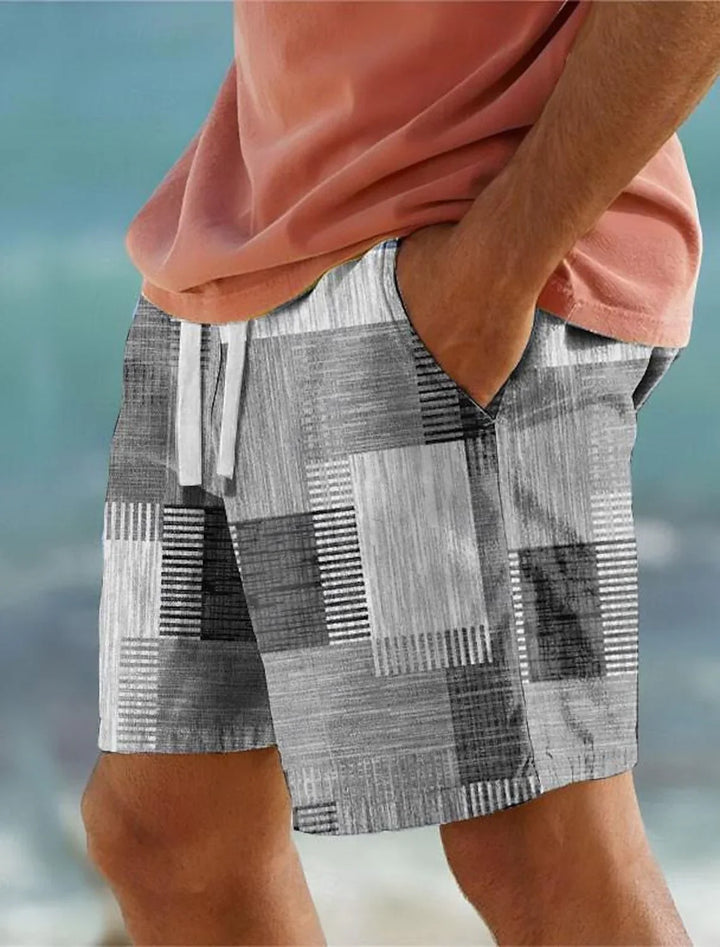 Close-up of man wearing black and white patchwork pattern casual shorts with drawstring and hand in pocket