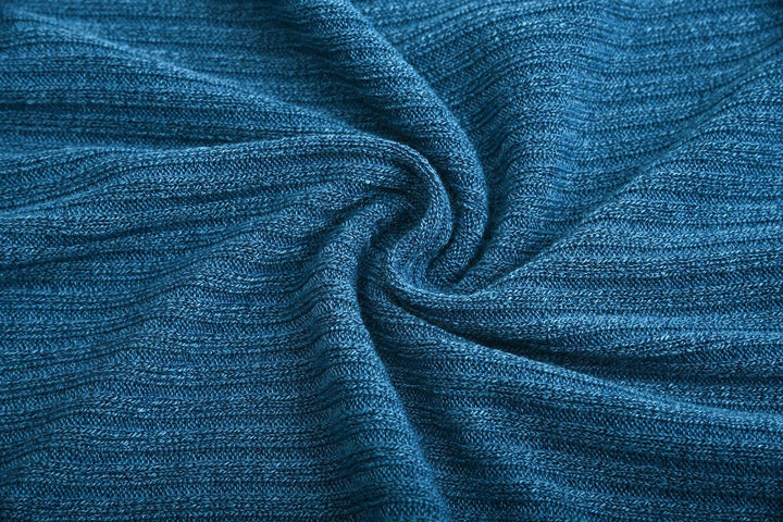 Close-up of blue knitted fabric with ribbed texture twisted in center