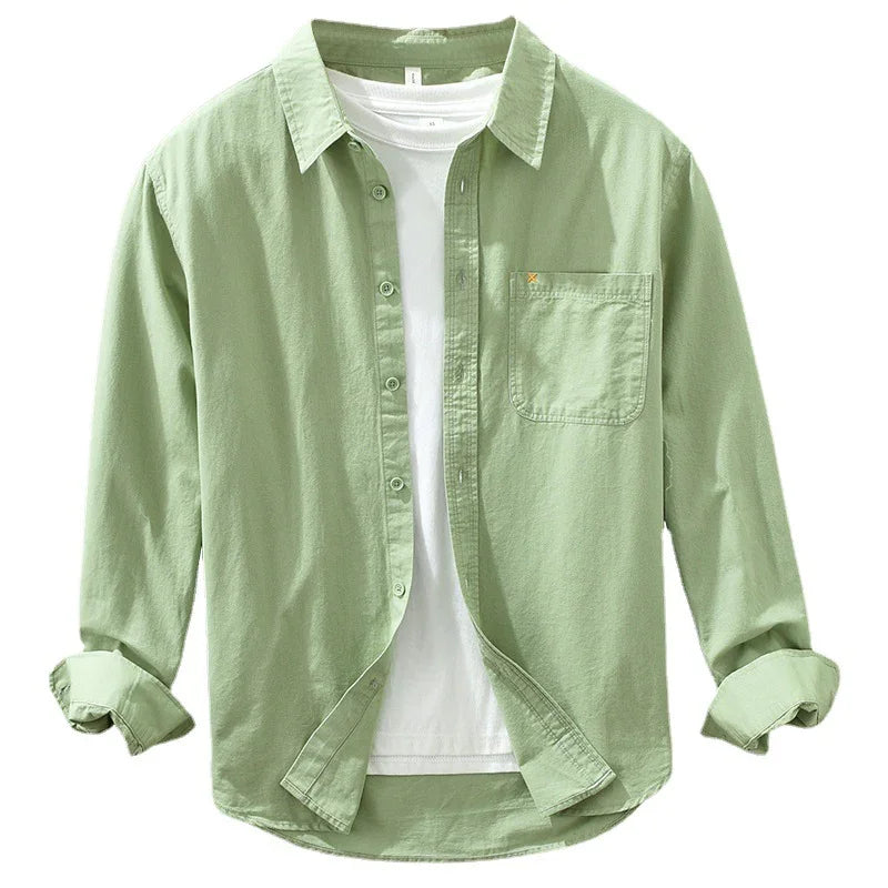Light green casual button-up shirt with chest pocket worn open over white t-shirt