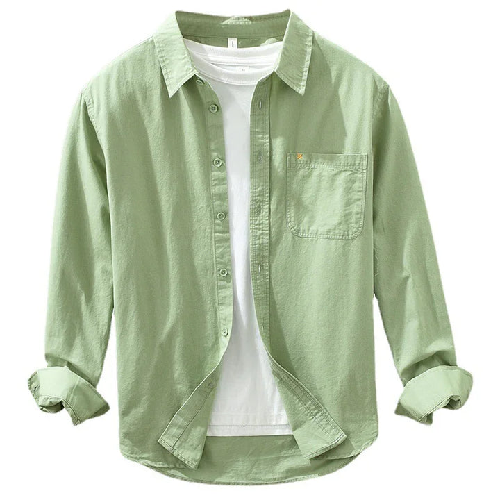 Light green casual button-up shirt with chest pocket worn open over white t-shirt