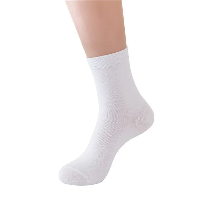 White ankle sock on a foot against a white background, showing texture and fit