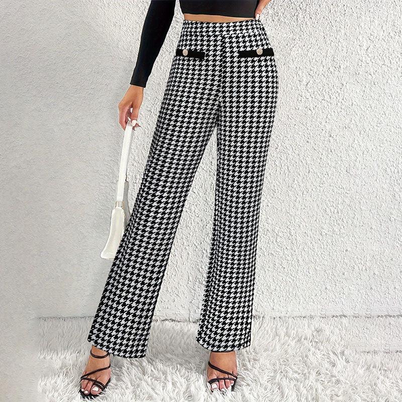 Woman wearing black and white houndstooth high-waisted wide-leg pants with gold button details