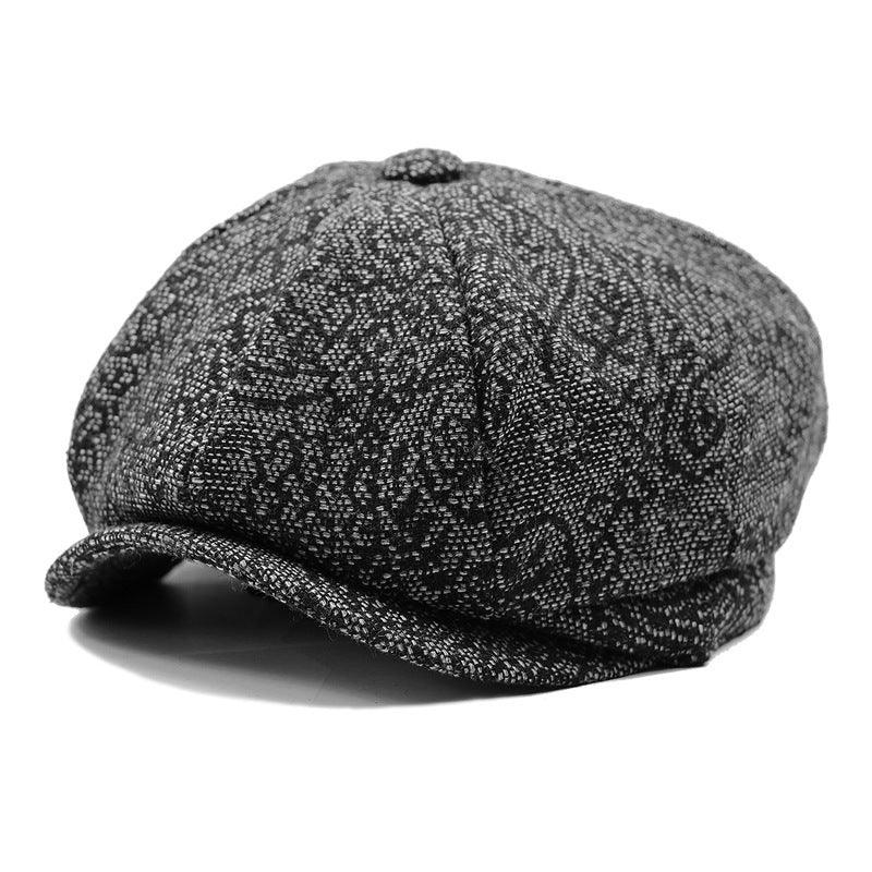 Black and gray patterned newsboy cap with textured fabric and rounded button top