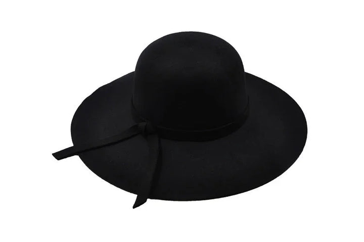 Black wide-brimmed hat with rounded crown and decorative ribbon bow on side
