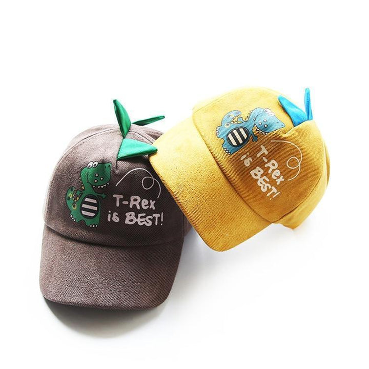 Two kids caps with cartoon T-Rex and text 'T-Rex is BEST!' in gray and yellow colors with dinosaur spikes