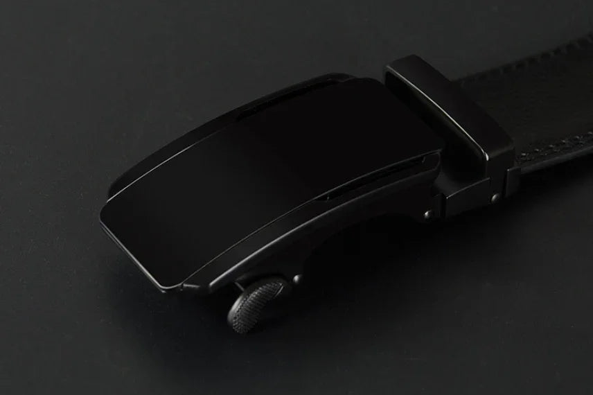sleek black automatic ratchet belt buckle on a black leather strap with textured adjustment wheel