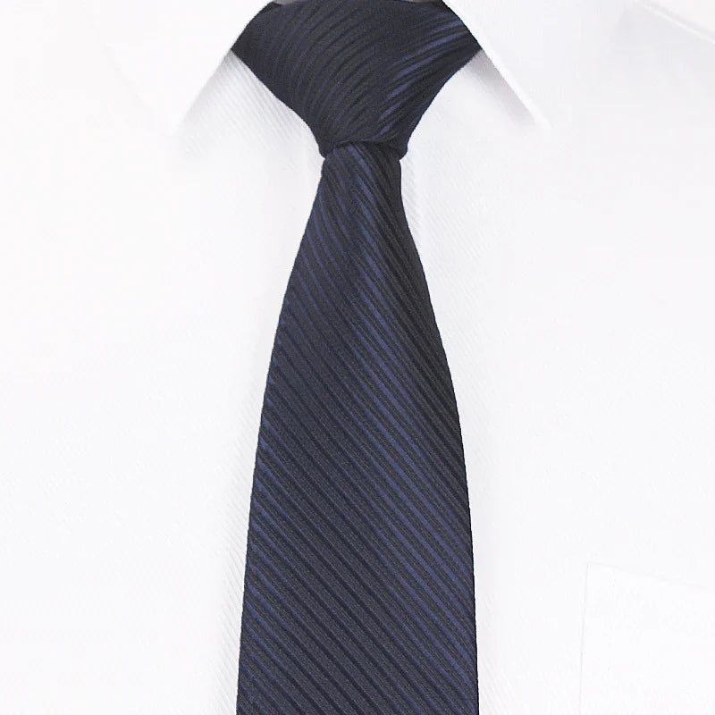 Navy blue striped silk tie on white dress shirt collar for formal business wear