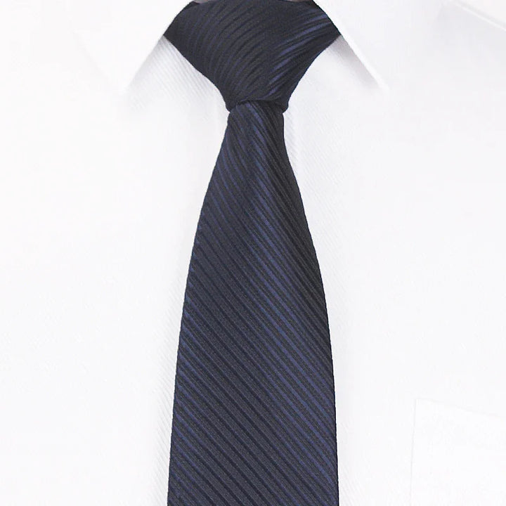 Navy blue striped silk tie on white dress shirt collar for formal business wear