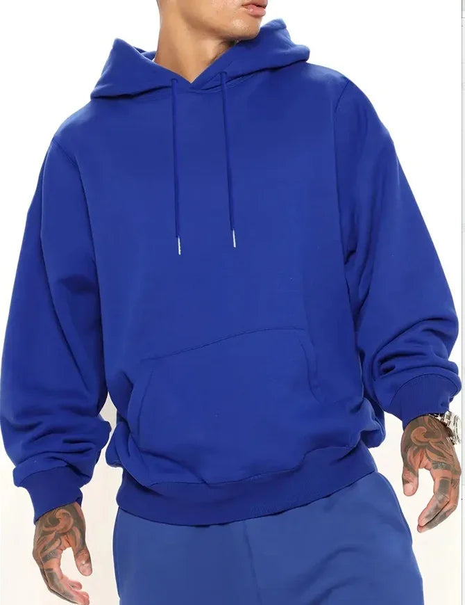 Man wearing plain royal blue hoodie with front pocket and matching blue pants