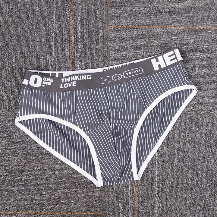 Grey men's briefs with white vertical stripes and printed waistband on textured surface