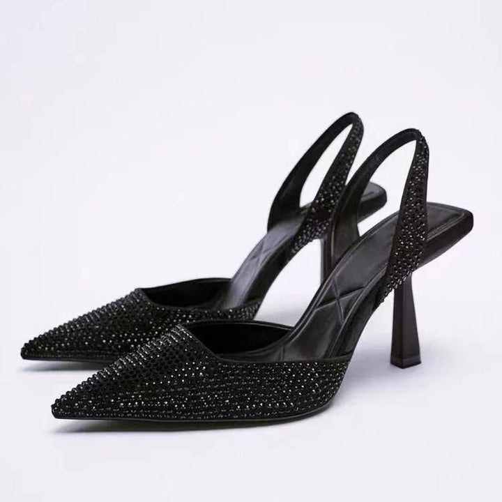 Black high heel slingback shoes with pointed toes and sparkling rhinestone embellishments