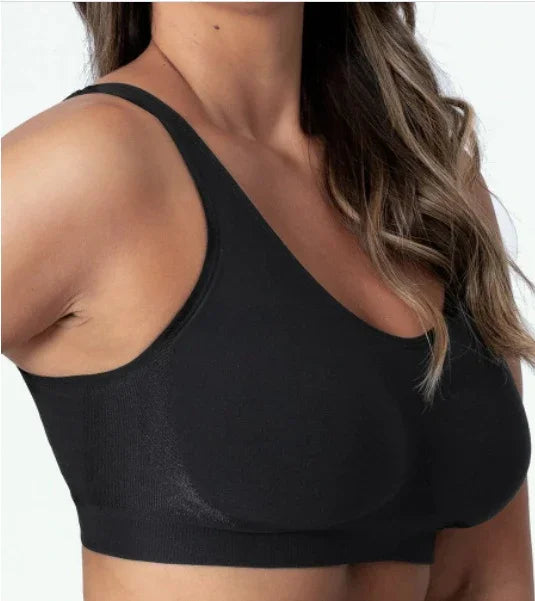 Close-up of a woman wearing a black seamless sports bra with wide straps and natural fit