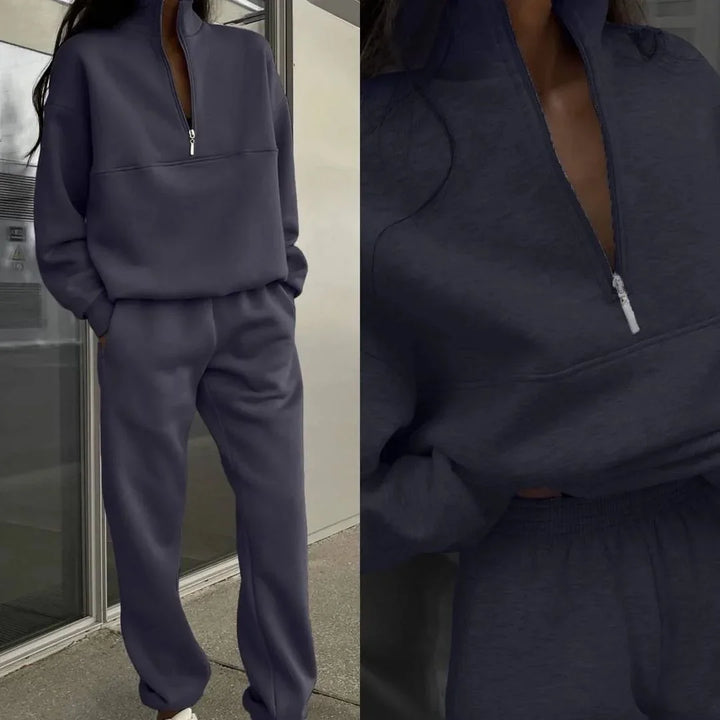 Woman wearing dark gray zip-up sweatshirt and matching sweatpants casual loungewear outfit