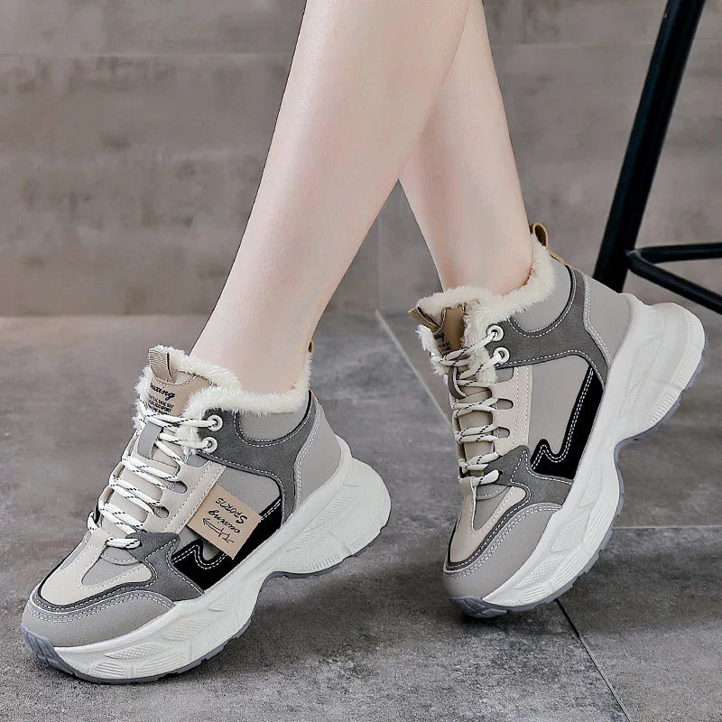 Women's beige and gray fur-lined chunky sneakers with white thick soles on gray tile floor