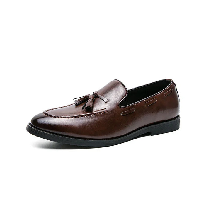 brown leather men's tassel loafers with black sole on white background