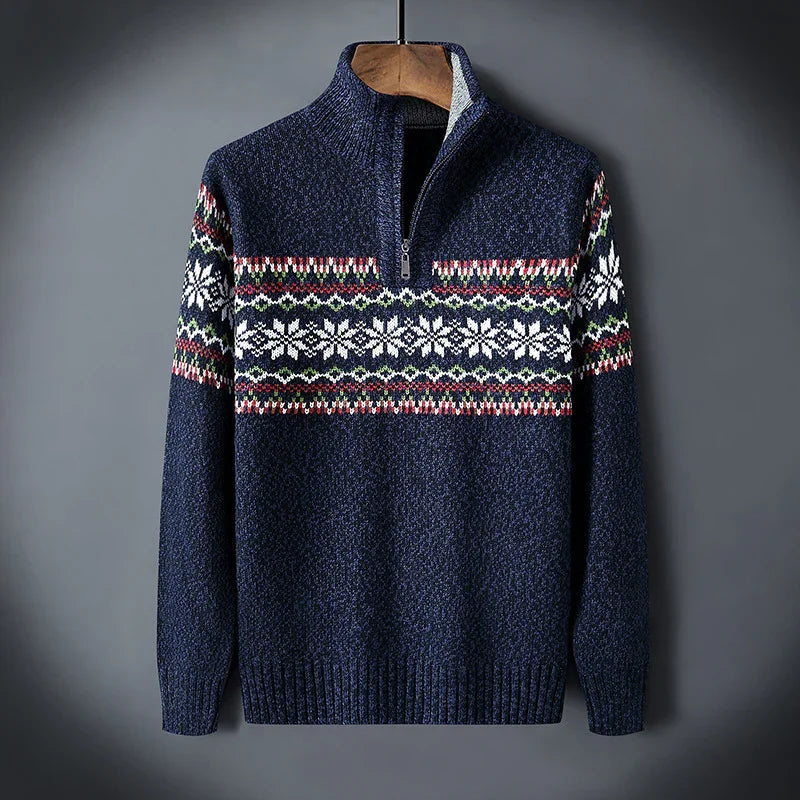 Navy blue knit sweater with half zipper and white snowflake pattern across chest and sleeves