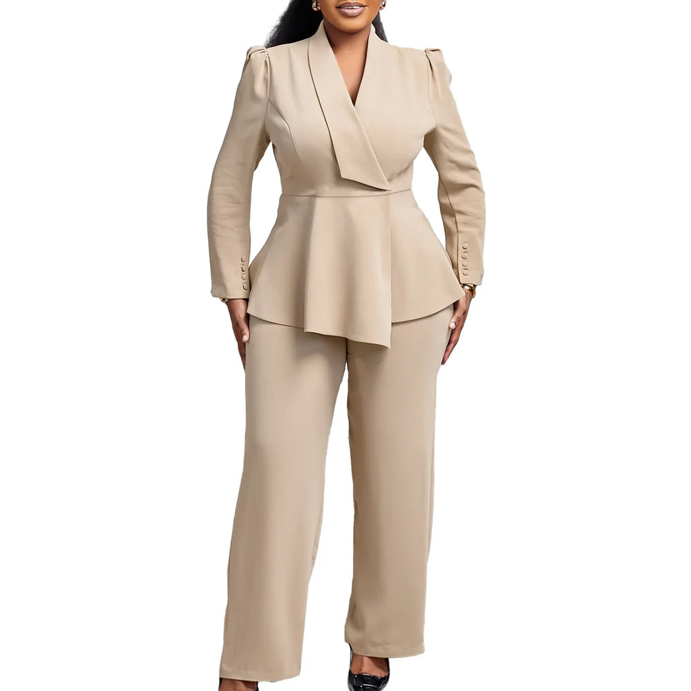 Woman wearing beige tailored pantsuit with peplum blazer and black heels