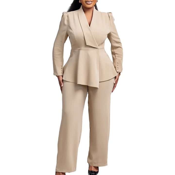 Woman wearing beige tailored pantsuit with peplum blazer and black heels