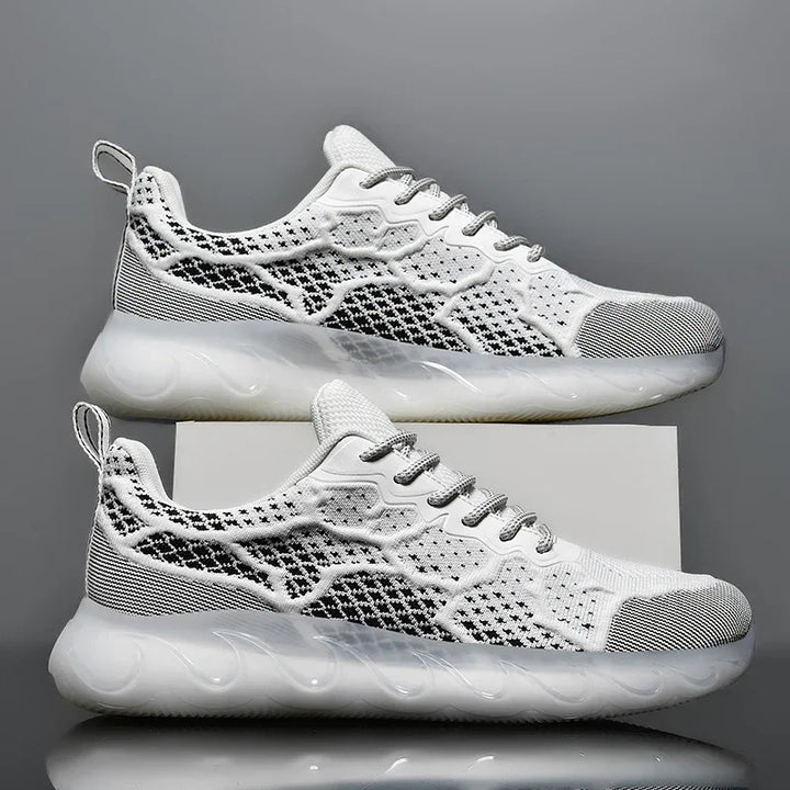 Pair of white and black knit pattern running shoes with thick translucent soles on grey background