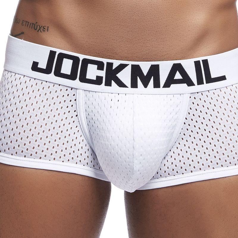 Close-up of white mesh Jockmail men's underwear with black logo waistband on tanned torso