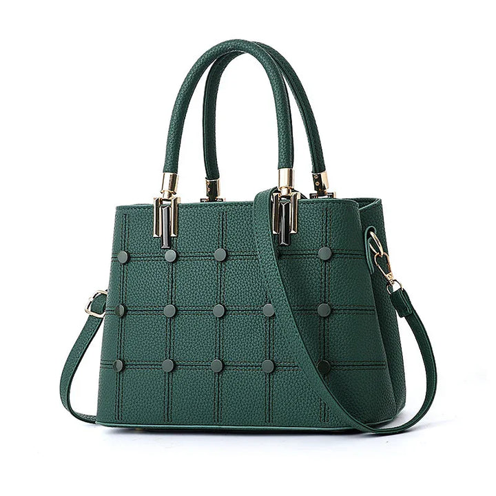 Green textured leather handbag with top handles, detachable shoulder strap, and metal stud detailing