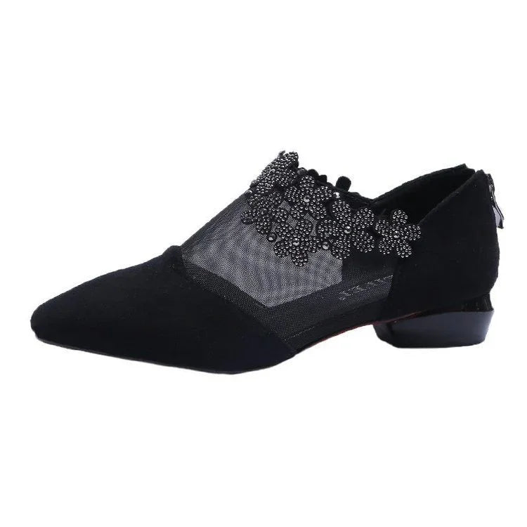 Black suede pointed toe flat shoe with mesh sides and beaded floral appliqué detailing