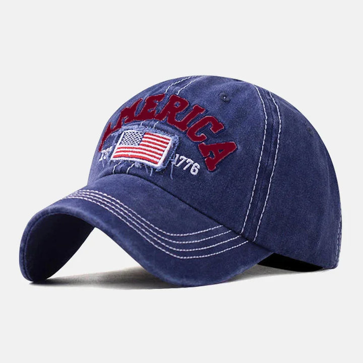 Blue vintage baseball cap with embroidered USA flag, America text, and 1776 detail